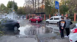 Hot water from a broken pipe in the city heating system floods a street in Kyiv, Ukraine