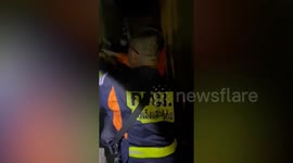 Rescuers drag gigantic python from family's roof