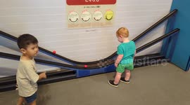 Boy Struggles to Grab Rolling Ball