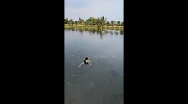 Woman floats with huge cat fish at fishing lake in Thailand