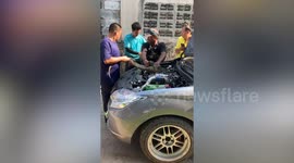 Large monitor lizard stuck inside car engine rescued