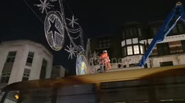 The Christmas lights get put up by workmen down The Strand in London