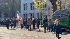 Group carrying patriotic flags light up flares as they march in Victoria, London