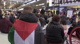 Palestine supporters hold sit-in protest at Waterloo station in London