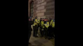 Police arrest far right protestor for carrying a Union Jack flag.