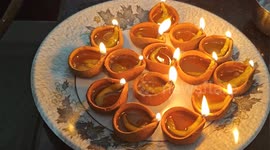 On the occasion for Diwali a Indian lady decorate hole corner diya own home for well wishes from God