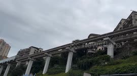 Chongqing's unusual metro: train passing through 19-floor apartment building