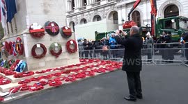Tourist asks the Cenotaph staff to take photographs of the wreaths on Remembrance Sunday 2023