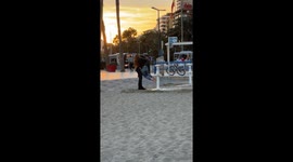Man Helps His Girlfriend Avoid Sandy Feet