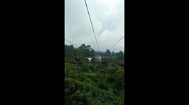 Tourists cycle on bikes suspended thousands of feet in the air