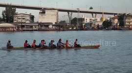 Rowers paddle furiously across Thai river for lively annual boat race