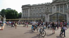 people wait outside Buckingham palace for news on the royal baby.