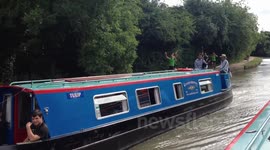 bagpipe player on a canal boat