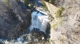 Drone plummets to the ground above stunning waterfall after clipping a tree