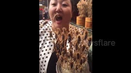 Woman eats live scorpions in China