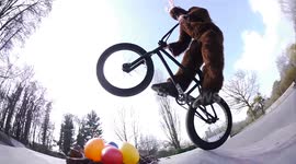 Man dressed as Easter Bunny does BMX tricks at skate park