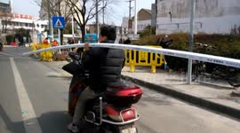 Man carries six-metre long pipe while driving a scooter