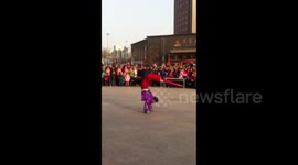 Young men walking on stilts show off dancing and martial arts