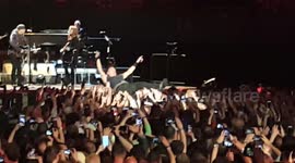 Bruce Springsteen crowd surfs and dances with fans at the Los Angeles Sports Arena in Los Angeles, CA