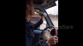 Man drinks and eats while driving