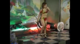 Woman plays hula hoops with fire on them