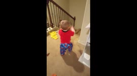 Toddler entertains himself by launching cars down the stairs