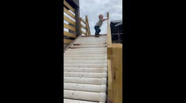 Kid Takes a Tumble on Roller Slide