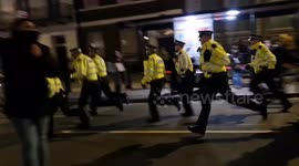 Police officers rush to the Cenotaph ahead of marching pro-Palestine protesters