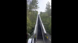 Giant escalator with mist spray takes tourists up mountain in China