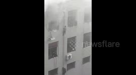 Miners climb down drainage pipe to escape blazing office building in China