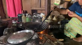 Indonesian woman is making a coffee in her traditional home, village Wae Rebo, Flores Island