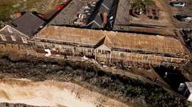 Former hotel perched on a crumbling cliff is taken apart brick-by-brick in East Sussex, UK