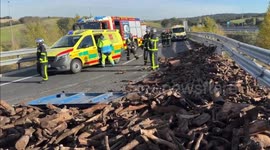 Truck overturns, tipping 10 tonnes of firewood onto road near Madrid, Spain