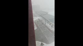 Woman blown over by wind slides along icy path in China