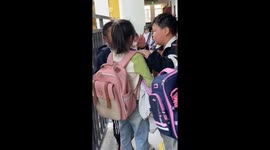 Kind schoolboy comforts sobbing girl in China