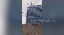 Philippines earthquake causes collapsing crane to dangle from building