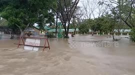 Families flee as floods submerge homes in central Philippines