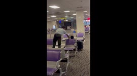 Airport staff hilariously wake up sleeping passenger about to miss flight