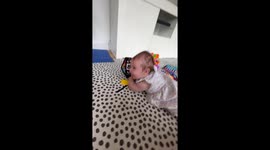 Baby giggles heartily when mum squeezes the squeaky toy for her *Wholesome*
