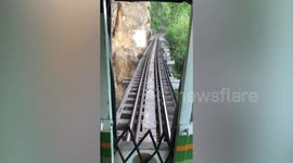 Nail-biting scene as dog follows train across mountain edge railway