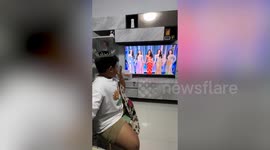 Beauty pageant fanboy wears crown and cape while watching Miss Grand Thailand 2023 broadcast