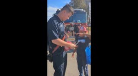 Heartwarming moment firefighter pokes hole in helmet so young boy with dreads could wear it
