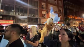 People listening and watching Milei's Victory Speech in Buenos Aires, Argentina