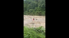 Father washed away by raging flash flood rescued by locals