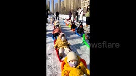 Parents transform snowfall into sledge fun for 20 joyful children in northern China