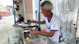 Street vendor serves manually scraped ice with fresh fruit juice