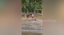 Pet dog plays football with schoolchildren in Laos