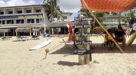 82-year-old German Santa Claus surfs at Hikkaduwa beach in Sri Lanka