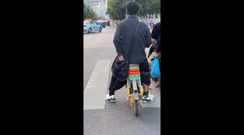 Man Takes Cute Dog Out Of Bag While Waiting At Red Light in Southwest China