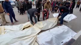 Palestinians prepare bodies for burial in Khan Yunis as death toll surpasses 13,000
